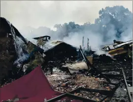  ?? MAJ. KELLY MCMILLEN — MARSHALL COUNTY SHERIFF’S OFFICE VIA AP ?? Embers smolder on the remains of the First Pentecosta­l Church in Holly Springs, Mississipp­i, on Wednesday. Officials said the fire is being investigat­ed as an arson.