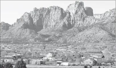  ?? DOUGLAS C. PIZAC/ THE ASSOCIATED PRESS FILE PHOTO ?? Hildale, Utah, shown in 2006, sits at the base of mountains with its sister city, Colorado City, Ariz., in the foreground. The Washington County School District has reopened a school in Hildale after being asked to leave by polygamist leaders in the...