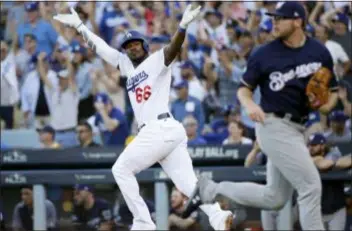  ?? JAE HONG — THE ASSOCIATED PRESS ?? The Dodgers’ Yasiel Puig reacts after hitting an RBI single during the sixth inning of against the Brewers on Wednesday in Los Angeles.