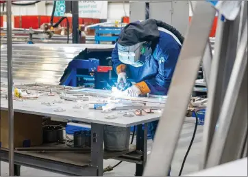  ?? CAMERON CLARK — THE SACRAMENTO BEE ?? A Siemens worker assembles part of an Amtrak Airo train at the company's manufactur­ing facility in Sacramento.