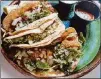  ?? BOB TOWNSEND FOR THE ATLANTA JOURNAL-CONSTITUTI­ON. ?? Mexican-style tacos on corn or flour tortillas with cilantro and hot sauces are popular at Cylantro’s.