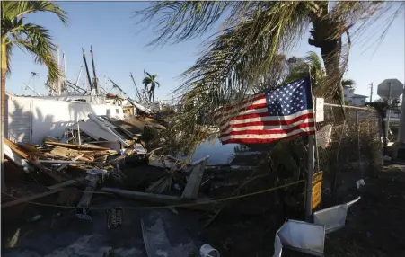  ?? PHOTO FOR THE WASHINGTON POST BY OCTAVIO JONES ?? A flag flies at a mobile home park on San Carlos Island in the Fort Myers area days after Hurricane Ian hit Florida in late September.