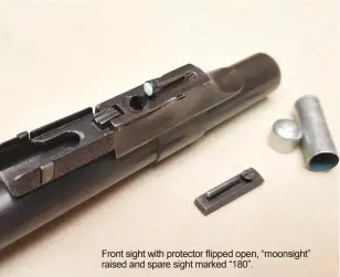  ??  ?? Front sight with protector flipped open, “moonsight” raised and spare sight marked “180”.