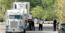 ?? PHOTO: REUTERS ?? Police officers work on a crime scene after eight people believed to be illegal immigrants were found dead inside a sweltering 18-wheeler trailer in San Antonio, Texas. A ninth has died in hospital.