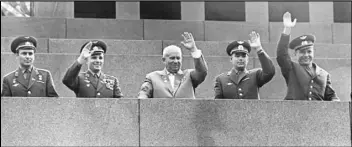  ?? ASSOCIATED PRESS ?? In this Aug. 18, 1962 file photo, Soviet Premier Nikita Khrushchev (center) is flanked by four Soviet cosmonauts as they wave from Lenin’s tomb in Moscow’s Red Square during a welcome ceremony for cosmonauts Andrian Nikolayev and Pavel Popovich who made a dual orbital space flight. From left are Gherman Titov, Yuri Gagarin, Khrushchev, Nikolayev and Popovich.