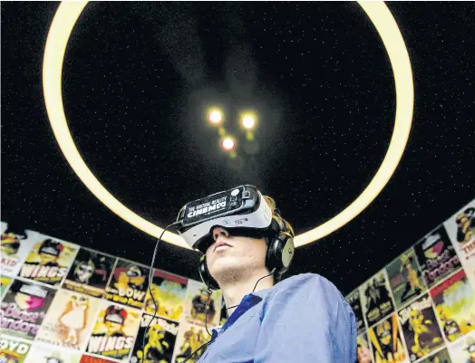  ??  ?? THE FUTURE IS HERE: A man wearing headphones and VR glasses watches films at the Virtual Reality cinema in Amsterdam.