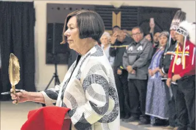  ?? ERIN POTTIE/CAPE BRETON POST ?? Marlys Edwardh, a retired Canadian civil rights lawyer who helped vindicate Donald Marshall Jr., carries a repatriati­on feather on behalf of Marshall’s family. A sacred symbol of First Nations culture, the feather was later presented to presiding provincial court judge Laurie Halfpenny MacQuarrie during the official opening of the court on Thursday at the Wagmatcook Culture and Heritage Centre.