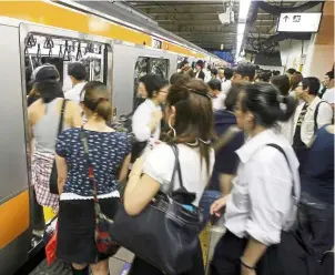  ?? — dpa ?? ‘Tsukin jigoku’ (commuter hell) is what the Japanese call the daily rush hour traffic on public transport.