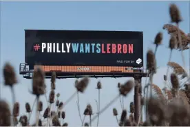  ?? ASSOCIATED PRESS FILE PHOTO ?? One of three billboards trying to entice Cavaliers superstar LeBron James to come to Philadelph­ia is shown near a highway in Cleveland.