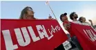  ?? AP ?? Supporters of Brazil’s Former President Luiz Inacio Lula da Silva, display banners with text written in Portuguese that read "Free Lula" during during a protest in front of the Superior Electoral Court.