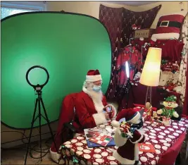  ?? SHERRY LAVARS — MARIN INDEPENDEN­T JOURNAL
Pole-like scene during his ?? Kenneth Brooks prepares for an online visit as Santa Claus on Wednesday at his home in Mill Valley. The green screen appears as a North
Zoom sessions.