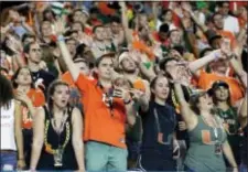  ?? LYNNE SLADKY — THE ASSOCIATED PRESS ?? Miami fans cheer during the second half over Notre Dame. of Saturday’s win