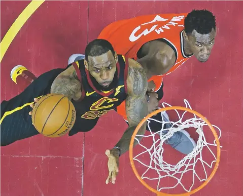  ?? PHOTOS BY TONY DEJAK/THE ASSOCIATED PRESS ?? The Cavaliers’ LeBron James, left, shoots against the Raptors’ Pascal Siakam, a former New Mexico State University Aggie, during Game 4 of a secondroun­d playoff series Monday in Cleveland. The Cavaliers won, 128-93, to advance to the conference finals.