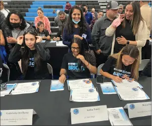  ?? COURTESY PHOTO ?? Signing certificat­es of commitment to attend college at Montclair
High School’s Senior
Signing Night in the school’s gymnasium on April 28 are, from left, Gabriela Orellana, Ashta Patel and Maya Pena.
