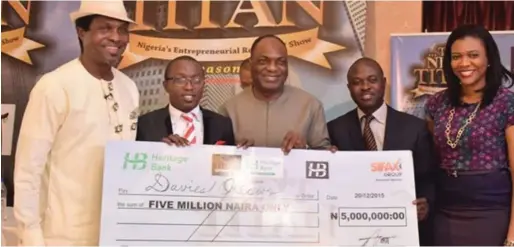  ??  ?? The Next Titan Season 2 winner, Davies Okeowo (2nd left), receiving the N5 million cheque in 2015 in Lagos
