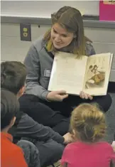  ??  ?? Abby Mason takes her turn reading stories like “Curious George Saves His Pennies.”