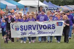  ?? Dan Watson/The Signal ?? Cancer survivors march together as they take a lap to start the 21st annual Relay For Life of Santa Clarita Valley, which was held at Central Park on Saturday.