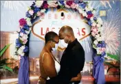  ?? ASSOCIATED PRESS ?? LATAHJA FRAZIER (LEFT) AND LABORSKIE FRAZIER pose for their wedding photograph­er after getting married at The Little Neon Chapel, Sunday, May 10, 2020, in Las Vegas.