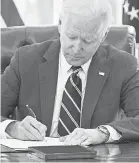  ?? MANDEL NGAN/ AFP VIA GETTY IMAGES ?? U. S. President Joe Biden signs the American Rescue Plan on Thursday.