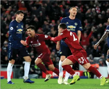  ??  ?? Xherdan Shaqiri celebrates after his deflected strike give Liverpool the lead at Anfield