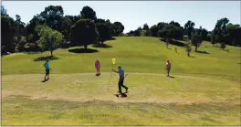  ?? FILE: SUSAN TRIPP POLLARD — STAFF ?? Bob Boling of Richmond takes the flag from the cup as he plays a round of golf with Wendy Oliver of Walnut Creek, left; Ann Gates of Pleasant Hill, center; and Joann Michel of Pleasanton on the last day of golf at Pine Meadow Golf Course in Martinez on April 12, 2015.