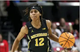  ?? JULIA NIKHINSON — THE ASSOCIATED PRESS ?? Michigan guard Ari Wiggins (12) dribbles the ball during a college basketball game against Maryland last month in College Park, Md.