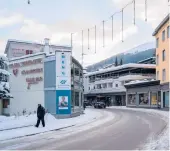  ?? CLARA TUMA/THE NEW YORK TIMES ?? A pedestrian makes his way along a mostly deserted area Jan. 9 in Davos, Switzerlan­d. Davos ditched its annual economic forum again.