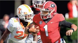  ?? / Athens Banner-Herald-Joshua L. Jones ?? Georgia quarterbac­k Justin Fields runs with the ball during the first half of the game against Tennessee.