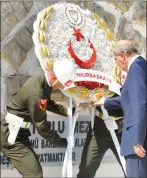  ?? ?? President Ersin Tatar laying a wreath at the Atlılar Martyrs Memorial. Right, President Tatar placing flowers at the graves of the Muratağa-Sandallar victims.