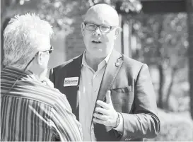  ?? Brett Coomer / Houston Chronicle ?? Kevin Roberts engages voters outside the polling place at Resurrecti­on Lutheran Church. The legislator has touted his political experience.