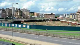  ?? ?? This is the view across central Bradford in August 2012 when constructi­on of a proposed shopping centre was on hold due to an economic recession. The photo is taken from the edge of the former Exchange station looking towards Forster Square station (the station’s Midland Hotel can be seen under the lamp post on the left) – showing just how close the two stations were to each other, and how tantalisin­gly little was needed to build a through line. This ‘hole’ existed in the city from 2006 until work on the shopping centre eventually resumed in early 2014, it opening the following year.