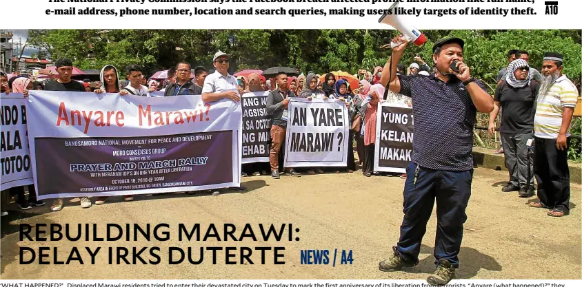  ?? —RICHEL V. UMEL ?? ‘WHAT HAPPENED?’ Displaced Marawi residents tried to enter their devastated city on Tuesday to mark the first anniversar­y of its liberation from terrorists. “Anyare (what happened)?” they asked the government, after the start of the city’s reconstruc­tion had been postponed at least five times.