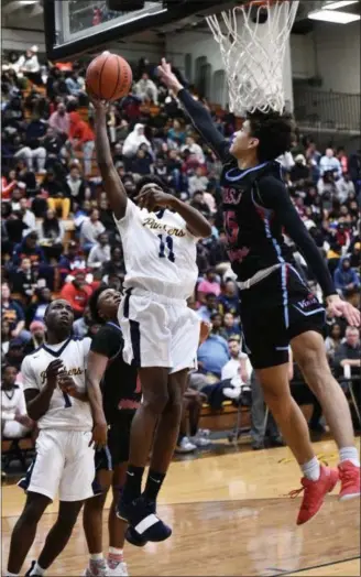  ?? PAUL DICICCO — FOR THE NEWS-HERALD ?? Euclid’s Jayron Cook goes to the basket as VASJ’s Jonah Waag defends on Feb. 9 on Euclid.