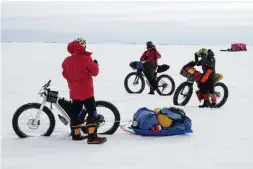  ??  ?? Writer Thomas Hall’s group takes a short break during their test trip. They cycled 45 kilometres in three days, slowed by the terrain and their Humvee-like “fat bikes.”