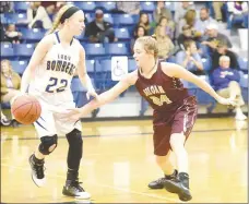  ?? Neal Denton/Special to Siloam Sunday ?? Siloam Springs sophomore Chloe Price, right, defends Mountain Home junior Hannah Pfeifer during the Lady Panthers’ 48-21 road loss to the Lady Bombers on Friday night.