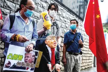  ?? — AFP photo ?? A pro-China activist holds an effigy of Trump during a protest outside the US consulate in Hong Kong.