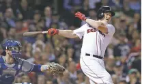  ?? CHARLES KRUPA/ASSOCIATED PRESS ?? The Red Sox’s Brock Holt follows through on his pinch-hit, three run home run off Blue Jays relief pitcher Ryan Tepera during Tuesday’s game in Boston. With the 7-2 win, Boston became the first team to clinch a playoff berth.