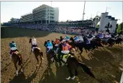  ?? AP PHOTO BY BRYNN ANDERSON ?? The field of 19 horses and riders bolt out of the starting gate during the 147th running of the Kentucky Derby at Churchill Downs, Saturday, May 1, 2021, in Louisville, Ky. The Kentucky Derby is moving closer to normalcy after two years of upheaval from the COVID-19 pandemic.