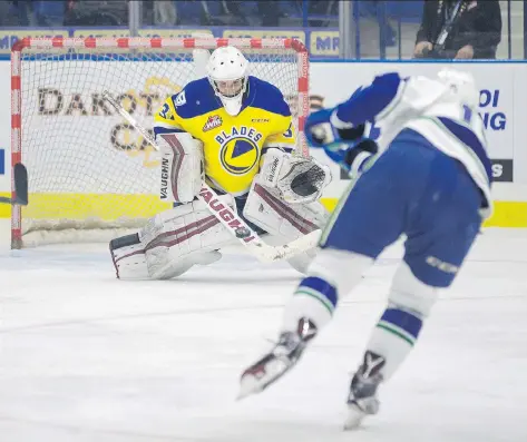  ?? KAYLE NEIS ?? Blades goalie Ryan Kubic turns away a shot by Swift Current Broncos forward Glenn Gawdin during Friday night’s WHL season-opener at the SaskTel Centre. The Blades jumped out to an early 2-1 lead on goals by Caleb Fantillo and Brad Goethals. For more...