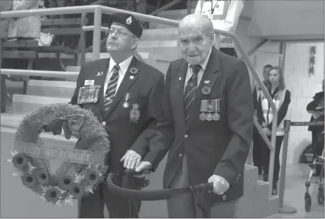  ?? Herald photos by J.W. Schnarr ?? Honorary Parade Marshal Joseph Green prepares to lay a wreath at the Cenotaph in Exhibition Park on Saturday morning. Green was an instrument mechanic who served as a corporal in Europe during The Second World War.