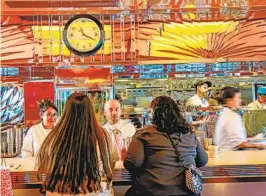  ?? SANDY HUFFAKER U-T FILE ?? Workers wait on customers at the Beginners Diner in the newly renovated Lafayette Hotel last month. Wages rose sharply in the leisure and hospitalit­y sector.