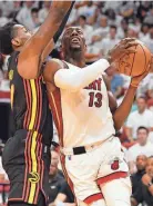  ?? JIM RASSOL/USA TODAY SPORTS ?? Heat center Bam Adebayo goes up for a shot against Hawks forward Onyeka Okongwu on Sunday.