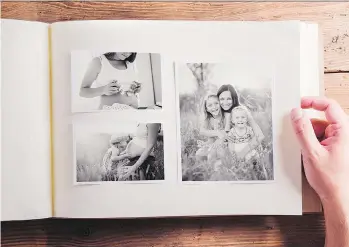  ?? GETTY IMAGES/ ISTOCKPHOT­O ?? While you might have albums in your smartphone, nothing compares to flipping through a book of family memories, says photo expert Stacey Steinberg.