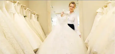  ?? KIRSTY WIGGLESWOR­TH/THE ASSOCIATED PRESS ?? A top-quality wedding dress typically starts with a consultati­on to explore what styles fit the bride. London bridal designer Phillipa Lepley says some labour-intensive designs can take 60-plus hours of work, depending on the embroidery.