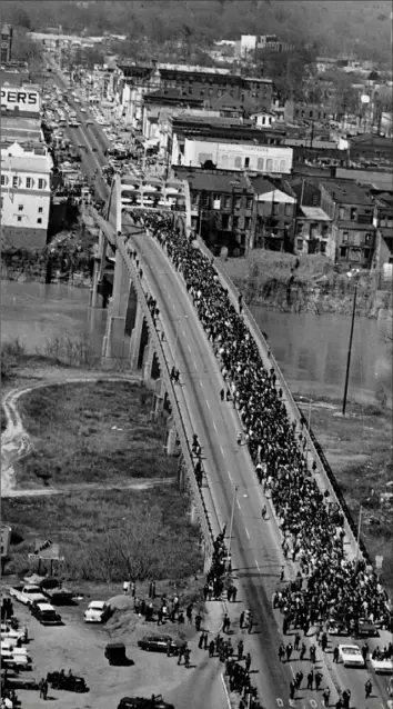  ?? AP Photo ?? This March 21, 1965, photo shows civil rights marchers crossing the Alabama River on the Edmund Pettus Bridge in Selma, Ala., on their way to the state Capitol in Montgomery.