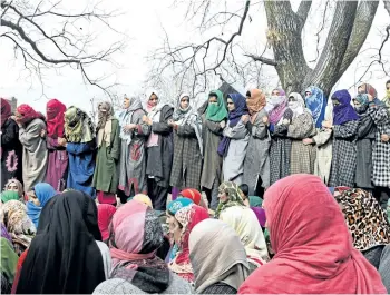  ?? TAUSEEF MUSTAFA/GETTY IMAGES ?? Kashmiri villagers look on during the funeral of militant commander Noor Mohammad in the Aripal village of the Tral district on Tuesday. Mohammad, the commander of a Pakistan-based militant group in Indian-administer­ed Kashmir, was killed by Indian...
