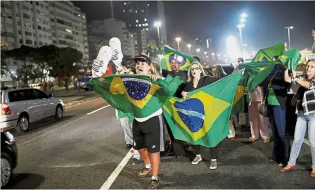  ??  ?? Reason for cheer: People celebratin­g after Lula was convicted on corruption charges and sentenced to nearly 10 years in prison in Rio de Janeiro, Brazil.