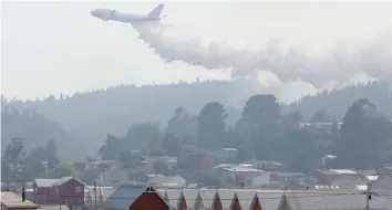  ?? — Reuters file photo ?? A Boeing 747-400 Super Tanker from the US drops water to extinguish wildfires in Chile’s central-south regions.