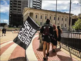  ?? JIM NOELKER / STAFF ?? Local protesters spent Aug. 30, 2020 marching around downtown Dayton in hopes of changing policing after the Jacob Blake shooting in Wisconsin.