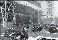  ??  ?? Shipyard workers in 1967 take a tea break during work on the QE2